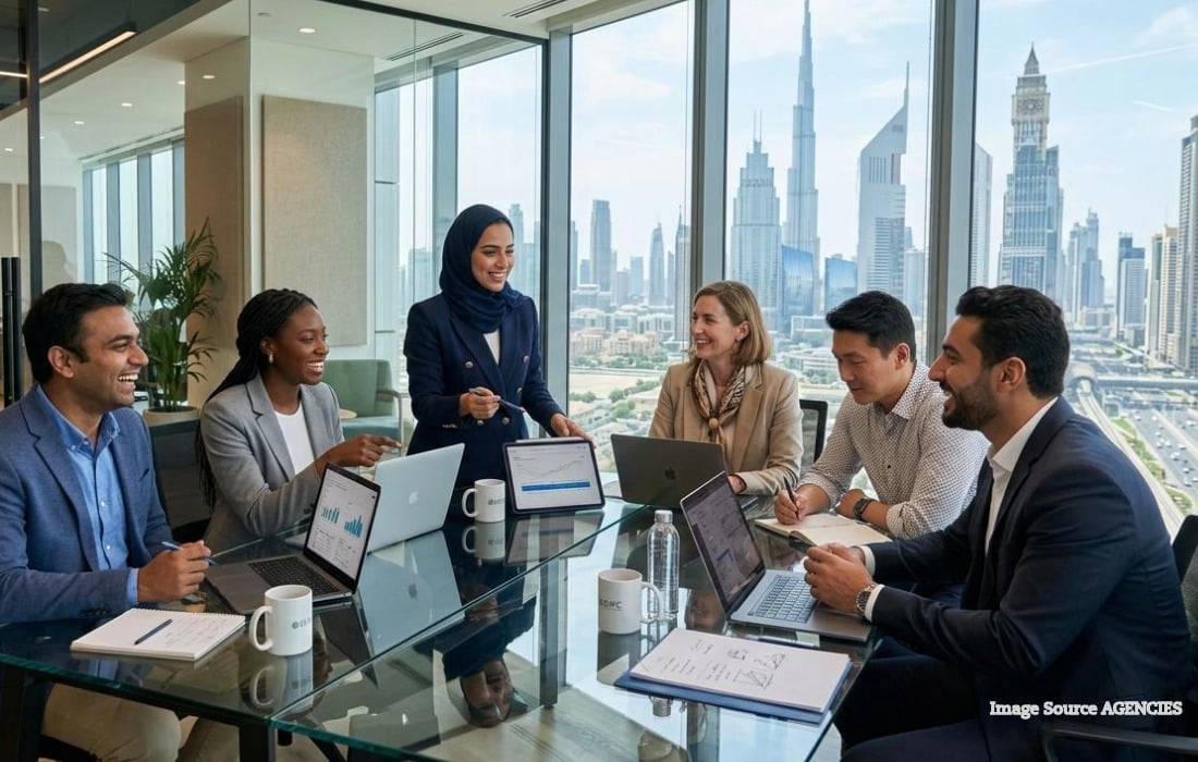 Employees working in a modern UAE office under UAE Labour Law workplace protections.