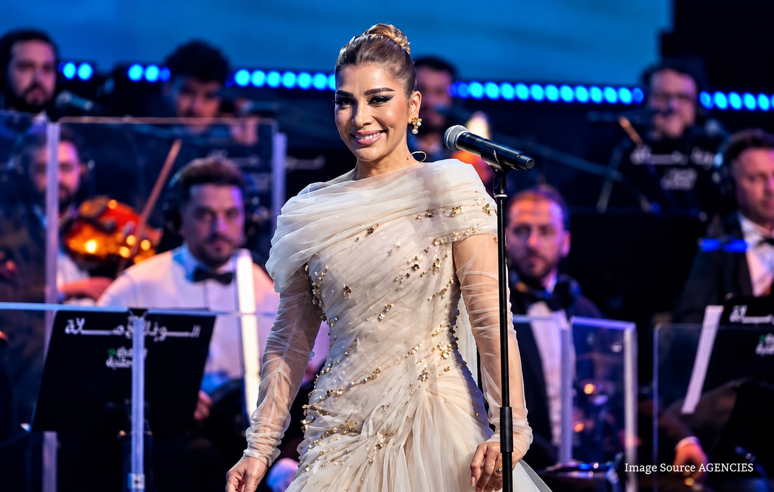 Assala performs on stage during her emotional homecoming concert at Al Fayhaa Sports Hall in Damascus.