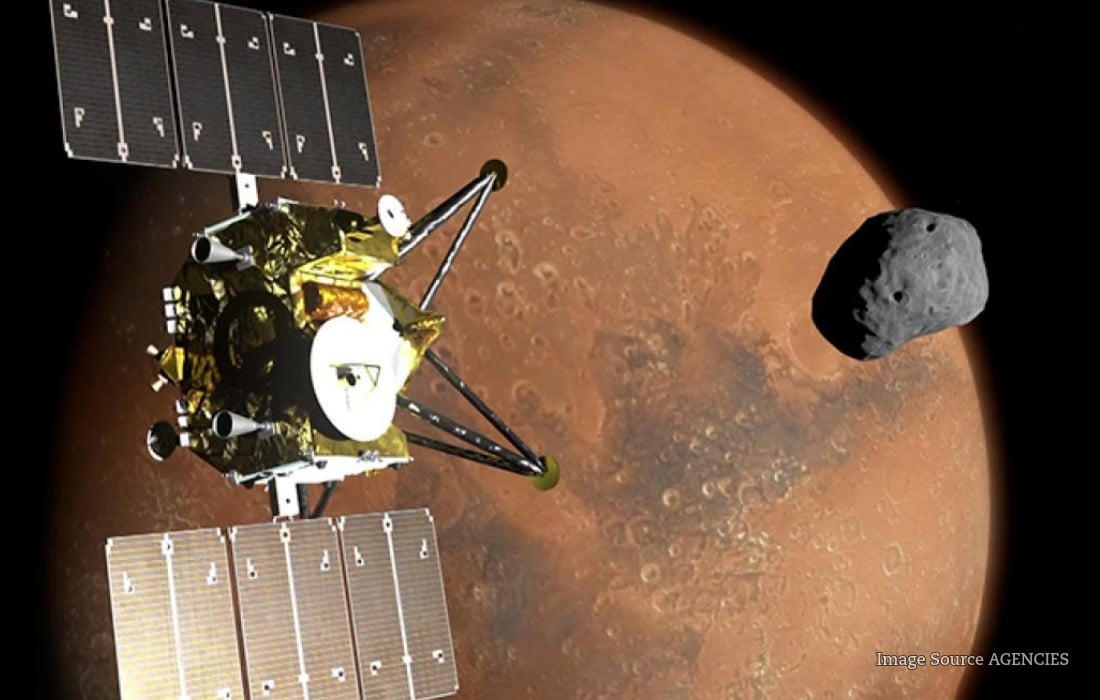 Illustration of Japan's MMX spacecraft exploring Phobos near Mars during its historic sample-return mission