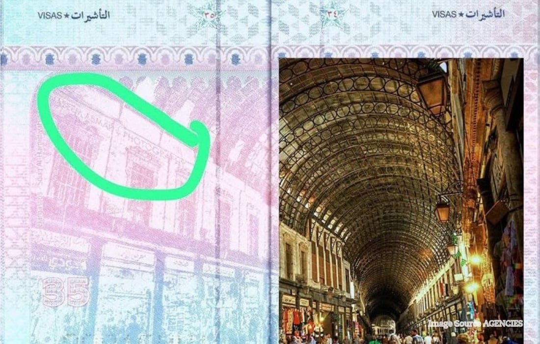 Syrian biometric passport page showing Souq al-Hamidiyah in Damascus with a photographer watermark visible on the image.