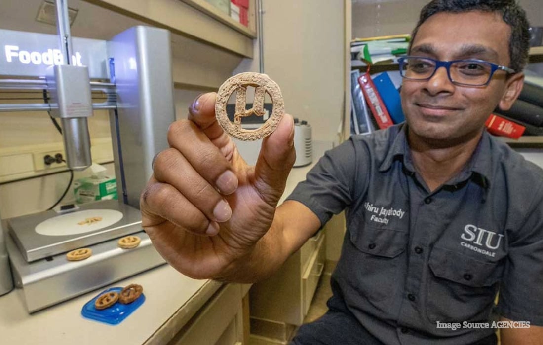 Dr Lahiru Jayakody holding a 3D-printed µBites cookie developed from ingredients derived from processed plastic and plant waste.