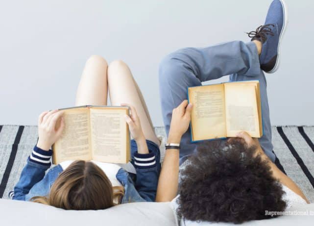Young Gen Z readers using smartphones alongside books as a TikTok debate raises questions about changing reading habits.